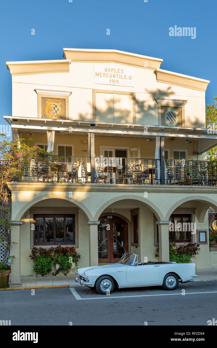 Classic 1965 Sunbeam Alpine Coup below historic Naples Mercantile Building along 3rd Street, Naples, Florida, USA Stock Photo