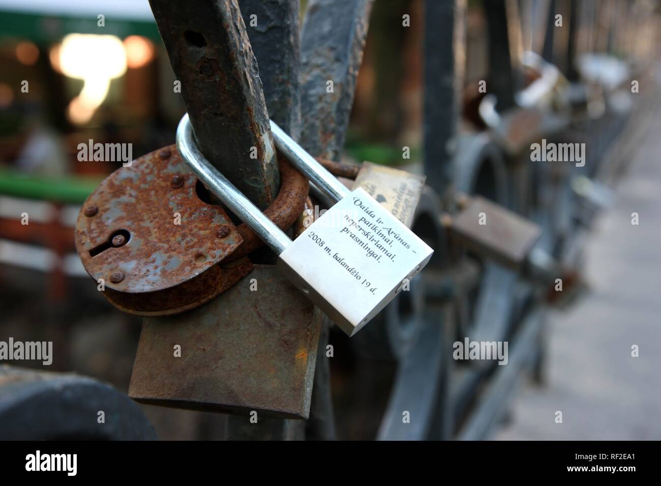 Padlocks engraved with the names of lovers locked to a bridge, Lithuanian tradition for newly weds, Vilnius Stock Photo