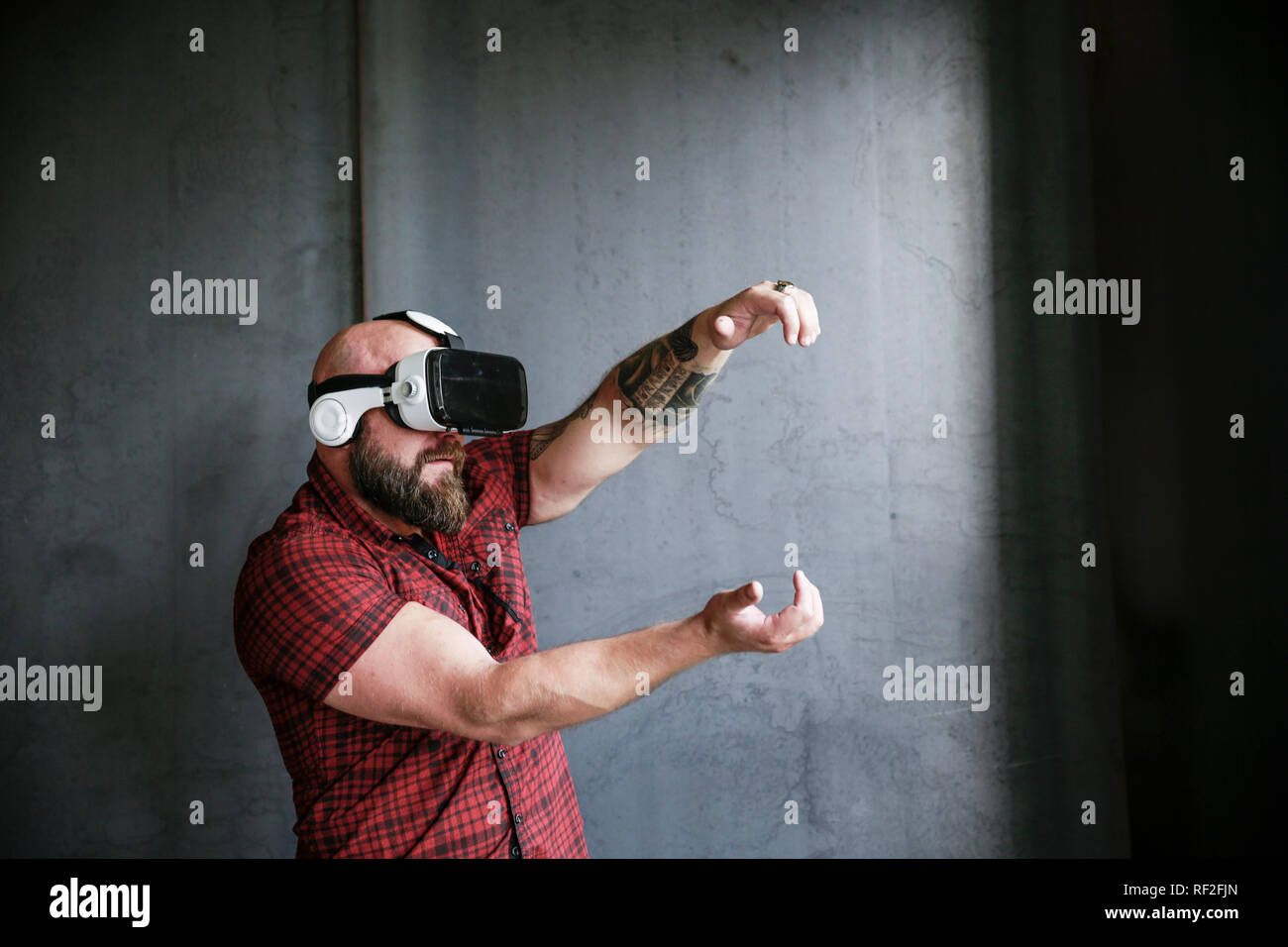 Bearded man wearing VR glasses Stock Photo