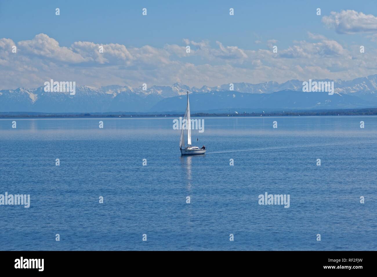 Lake Ammer with sailboat and the snow-covered Alpine peaks in the background, Lake Ammer, Herrsching, Bavaria, Germany Stock Photo