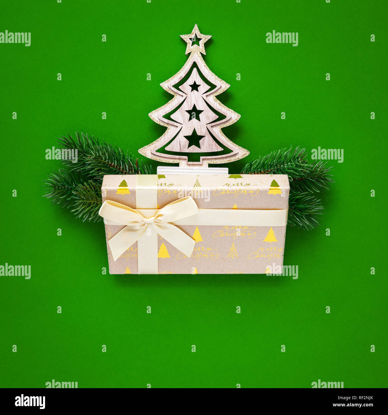 A Christmas decoration green background with fir tree and gift box ...