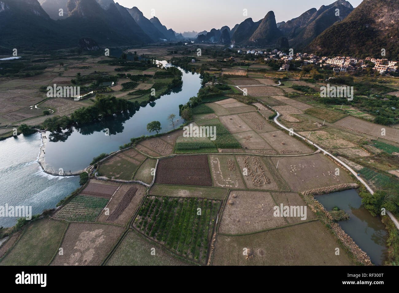 Low aerial view of the Karst mountains, water,  and rice fields along the pearl river in china seen from an hot air balloon Stock Photo