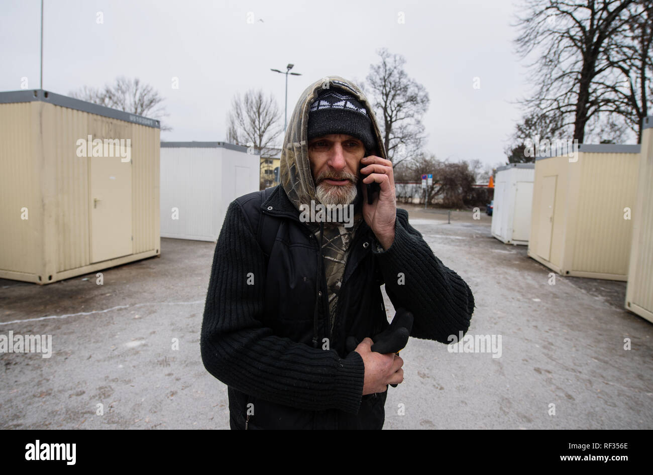 22 January 2019, Rhineland-Palatinate, Mainz: Günni (50) stands between the living containers and calls his daughter. The father of a daughter (29) spent 22 years in prison, according to his own statement. He's currently dry and off the drugs thanks to the substitute drug Subutex. He prefers to sleep on the street or in empty houses, in the official accommodations there is always trouble, fights, alcohol problems and thefts. Over the winter, the city of Mainz has set up residential containers for the homeless at Fort Hauptstein near the main railway station. The Evangelische Wohnungslosenhilfe Stock Photo
