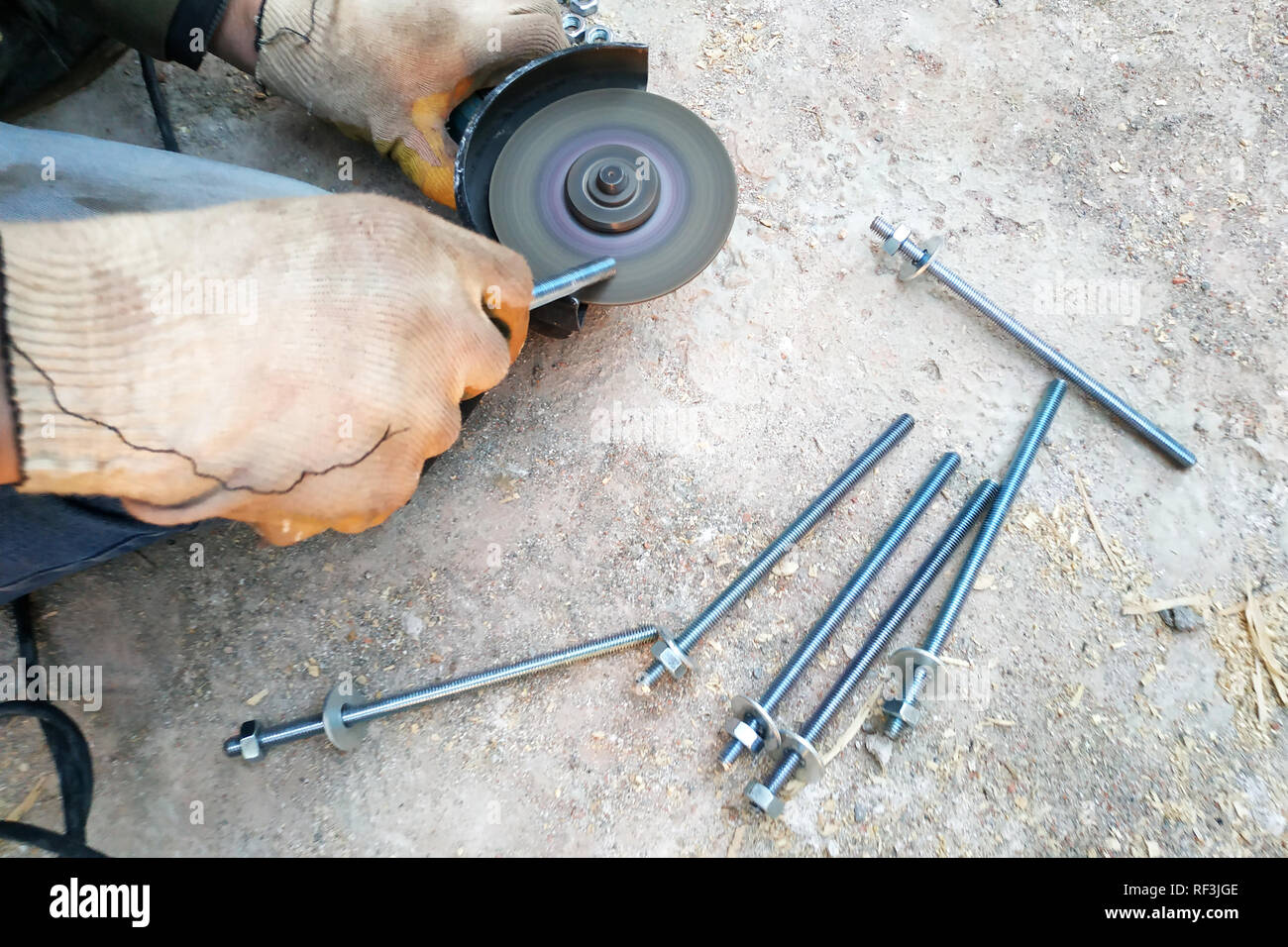 The master cuts and bolts the bolts using an angle grinder 2019 Stock