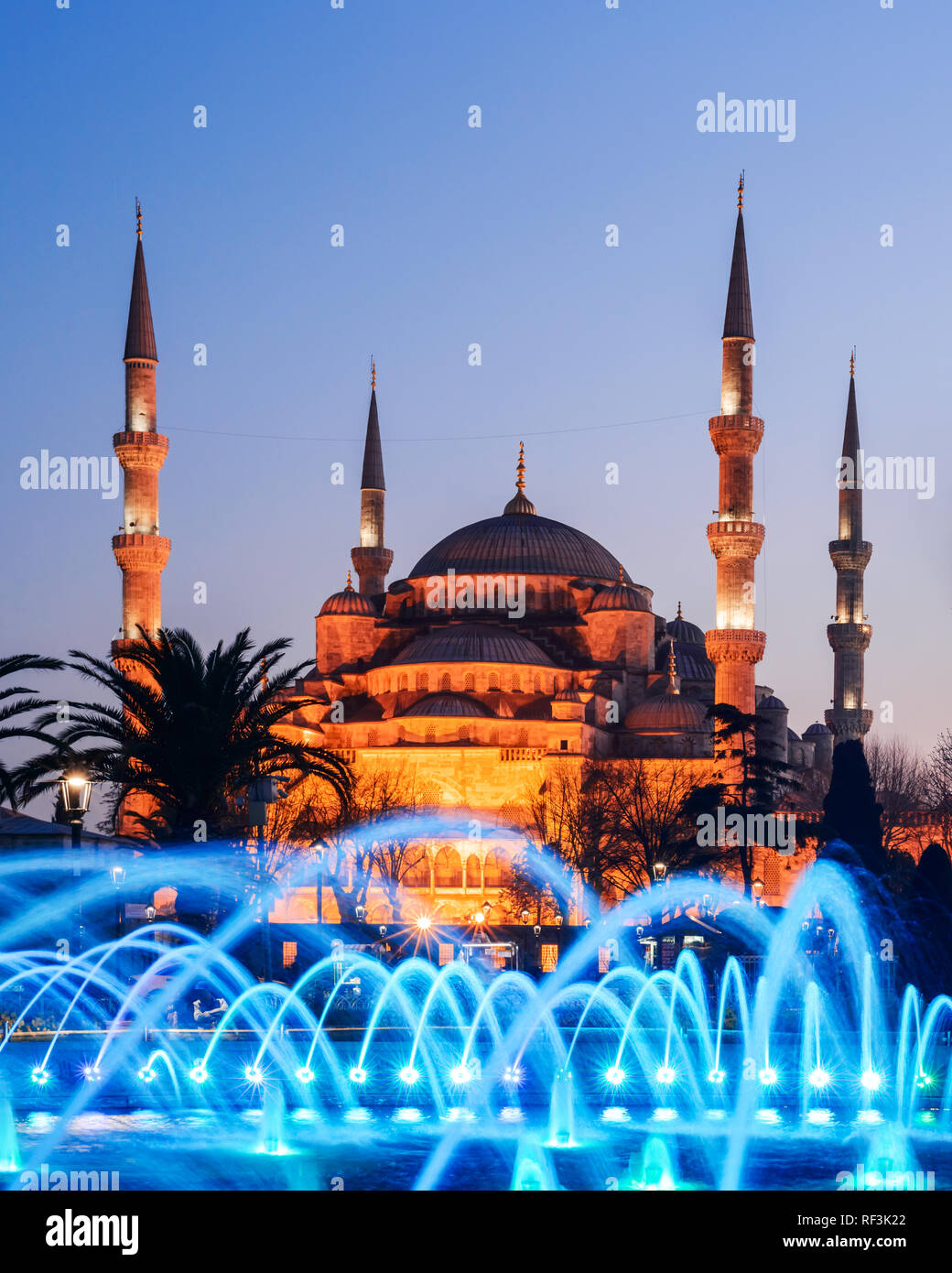Fountain on Sultanahmet area in evening time. Multicolored streams against the background of the Blue mosque. Located place: Istambul, Turkey Stock Photo