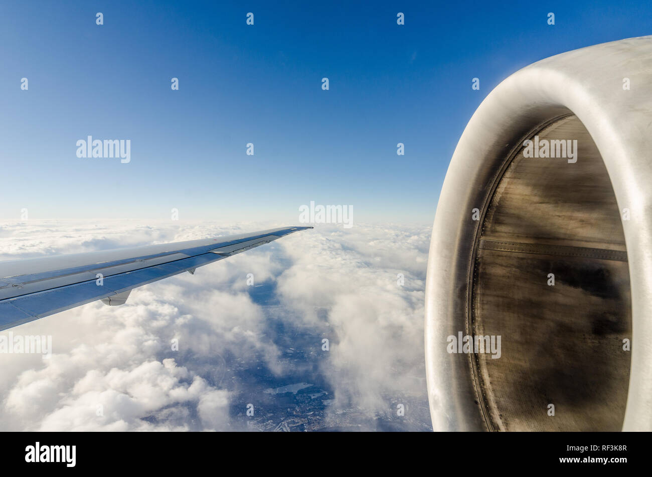 Airplane wing flying above the clouds Stock Photo