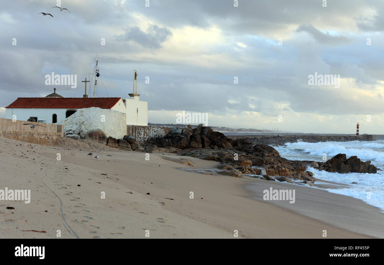 XI century chapel of Senhora da Guia near the sea in Vila do Conde, Portugal; end of the day light Stock Photo