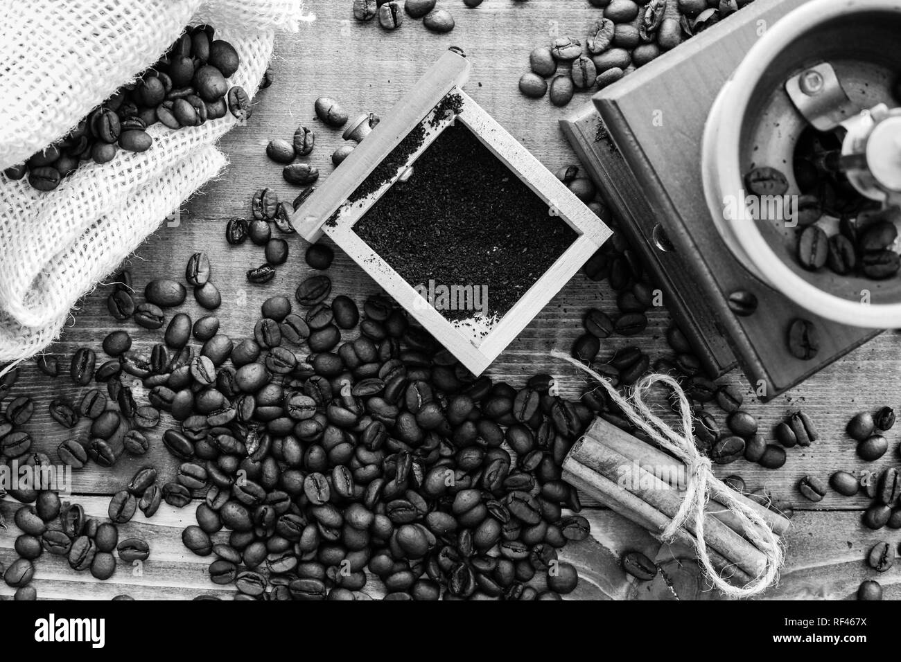 Manual coffee grinder on wooden table top view in black and white Stock Photo