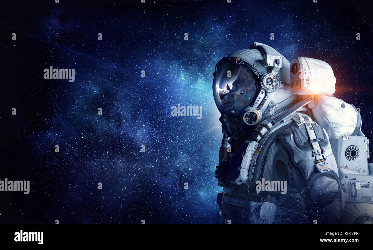 Astronaut rhino wearing space suit against starry sky. Mixed media ...