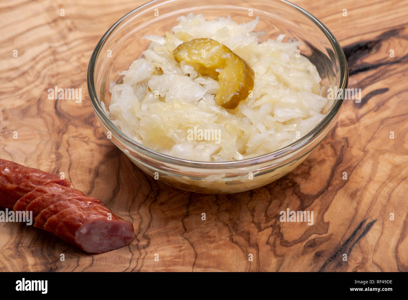 Traditional organic raw and fermented sauerkraut with pickled Persian cucumbers and grass fed beef smoked sausage stick Stock Photo