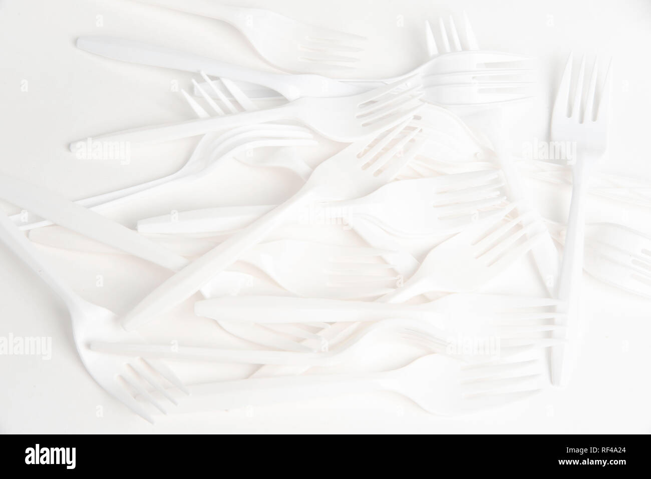 A bunch of white disposable singleuse plastic forks commonly available