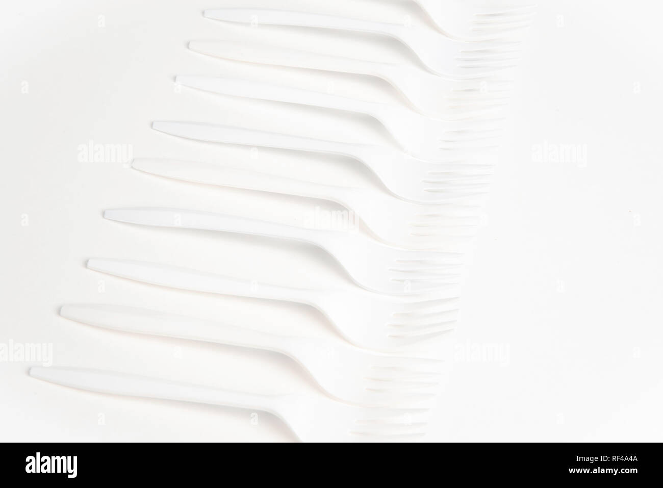A bunch of white disposable singleuse plastic forks commonly available