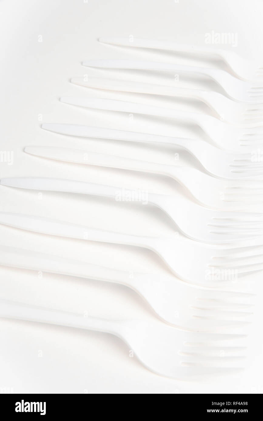 A bunch of white disposable singleuse plastic forks commonly available