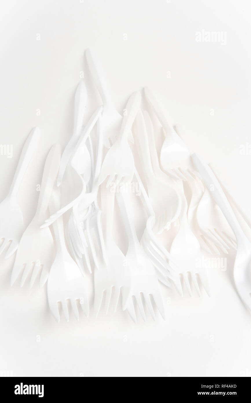 A bunch of white disposable singleuse plastic forks commonly available