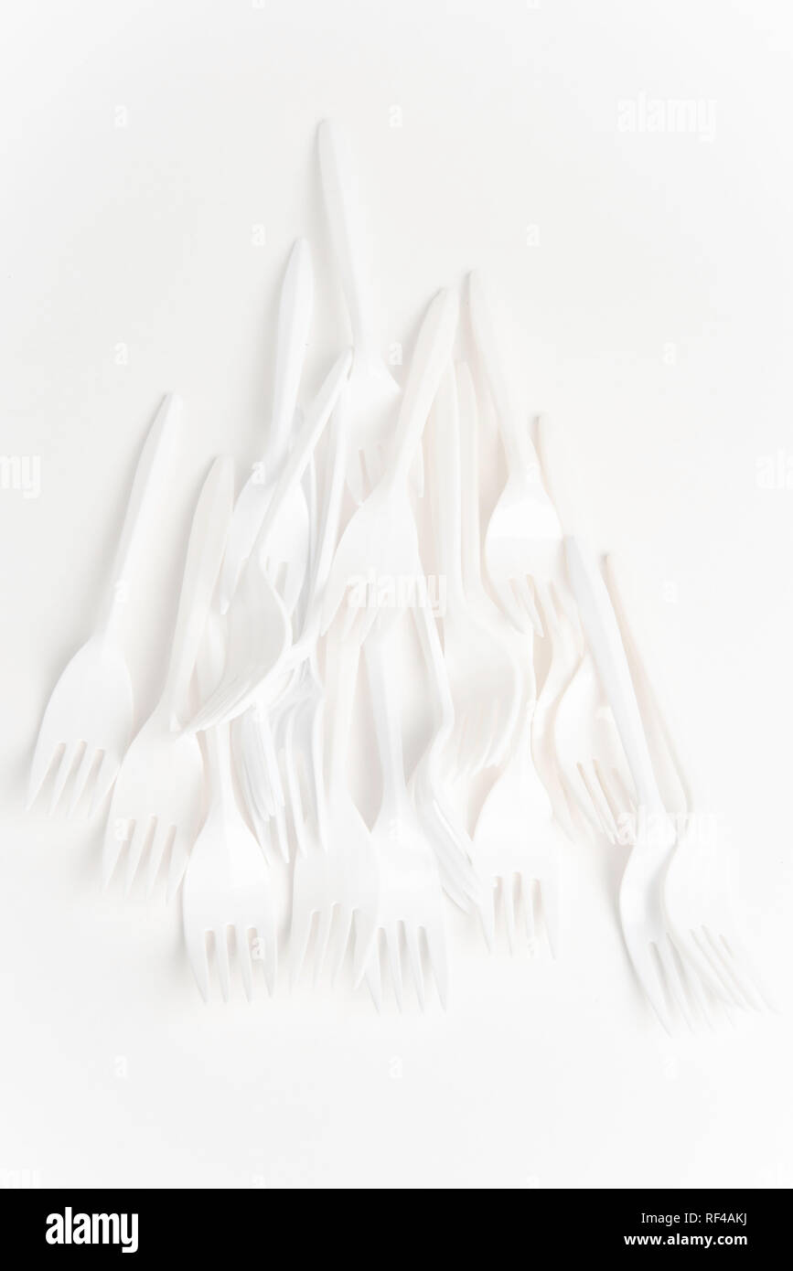 A bunch of white disposable singleuse plastic forks commonly available
