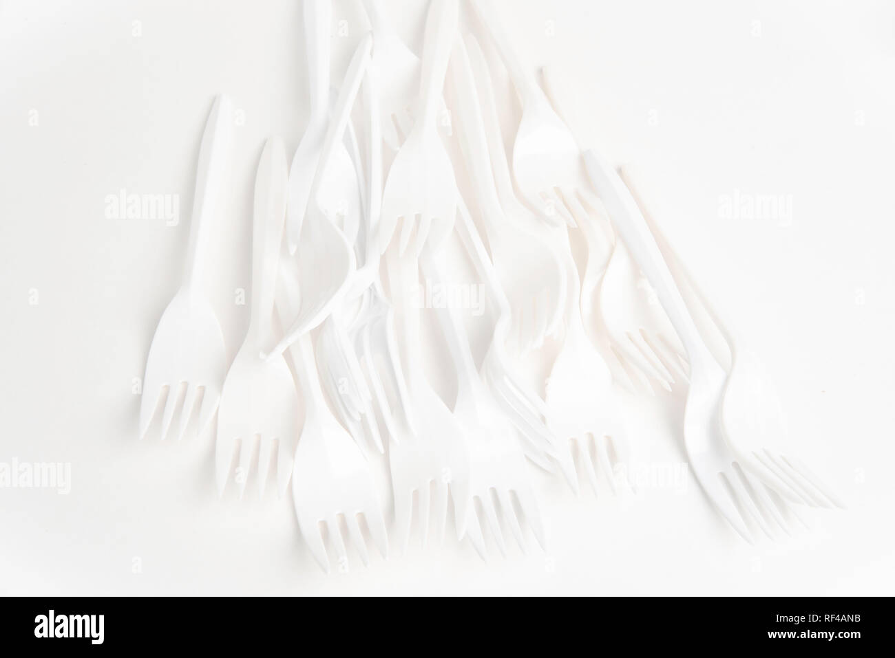 A bunch of white disposable singleuse plastic forks commonly available