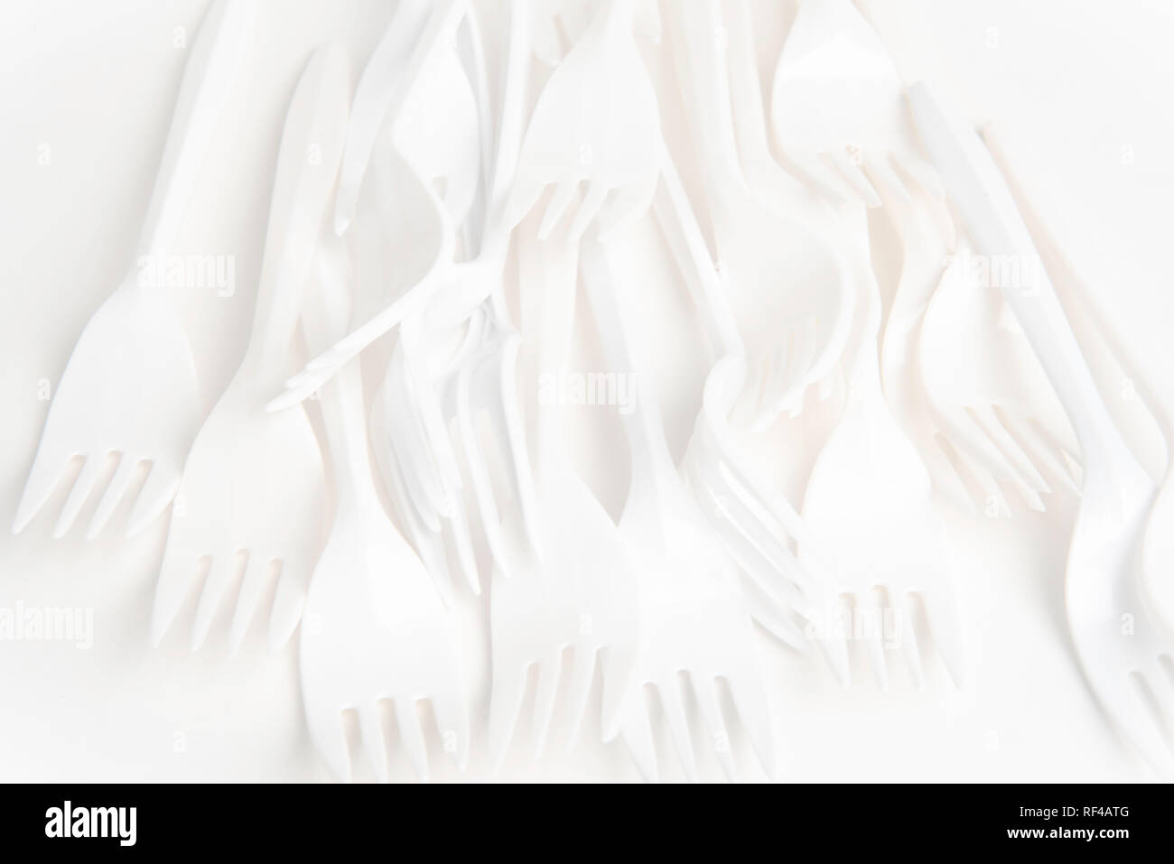 A bunch of white disposable singleuse plastic forks commonly available all over the world Stock