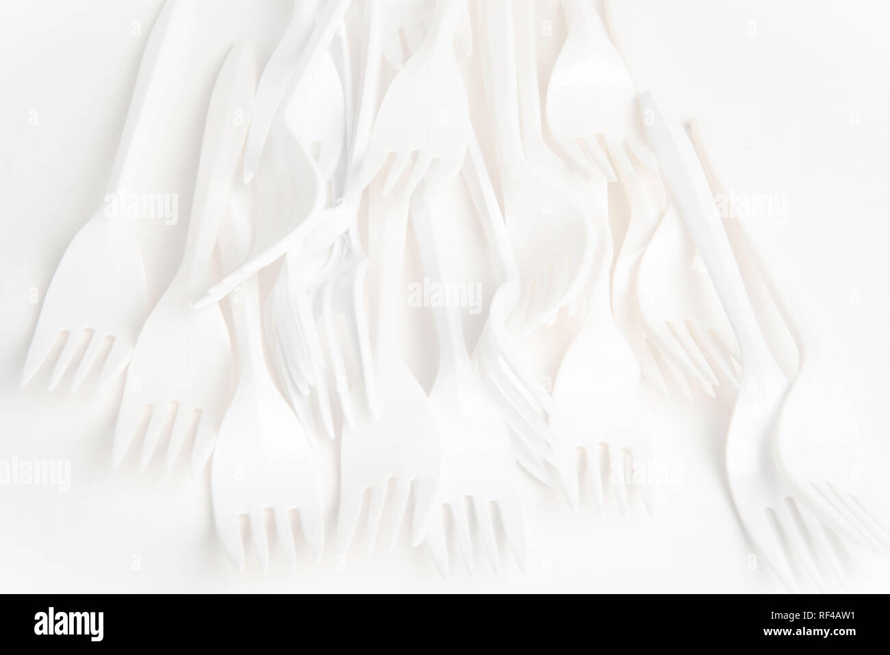 A bunch of white disposable singleuse plastic forks commonly available