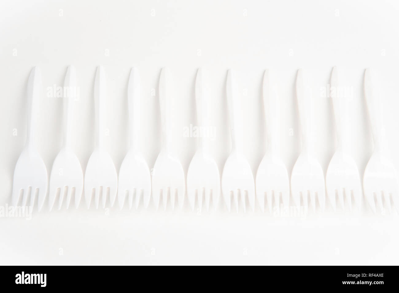 A bunch of white disposable singleuse plastic forks commonly available