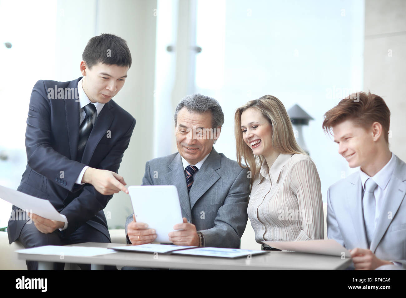 project Manager and business team use a digital tablet to obtain operational information Stock Photo