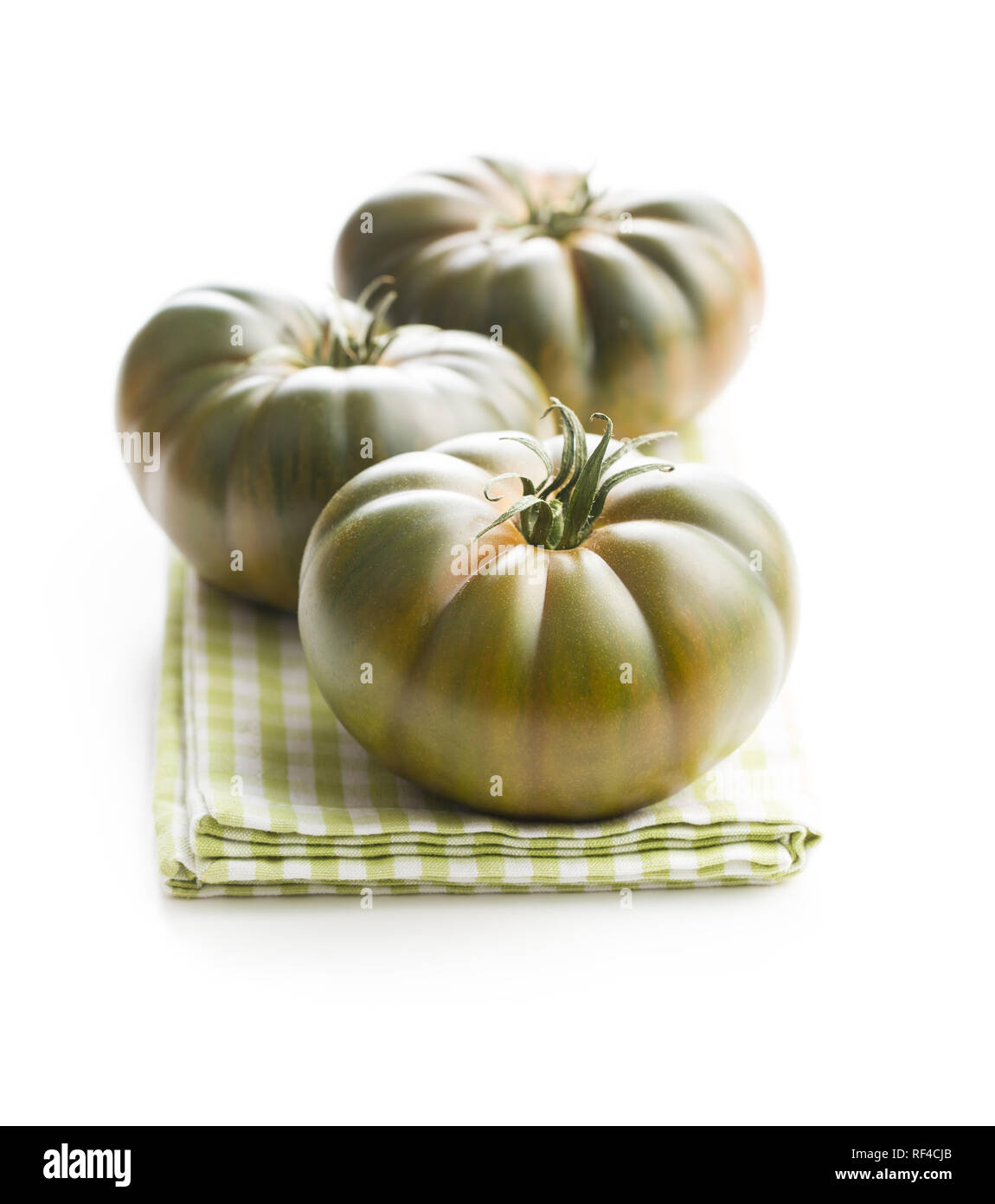 Dark brandywine tomatoes isolated on white background. Stock Photo
