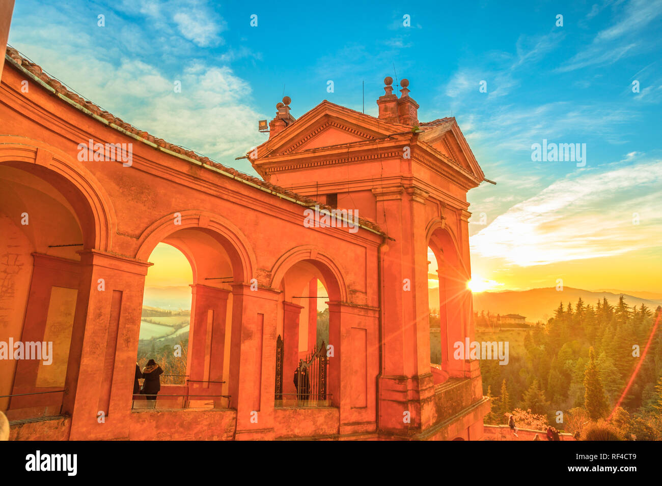 Side view of Sanctuary of Blessed Virgin of San Luca and Colle della Guardia above city of Bologna. Scenic sunset light. Famous landmark cityscape in Emilia-Romagna, Italy. Stock Photo