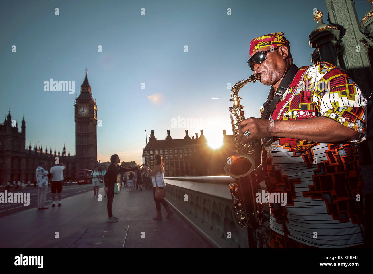 Saxophone player on the street. Famous London tourist location. Big Ben and Westminster Stock