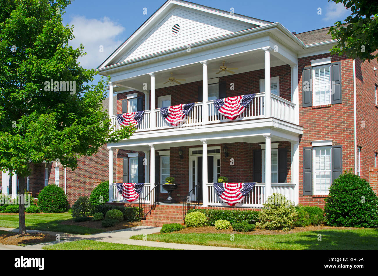 Patriotic American Flag Bunting Hung on a Brick House with a White ...