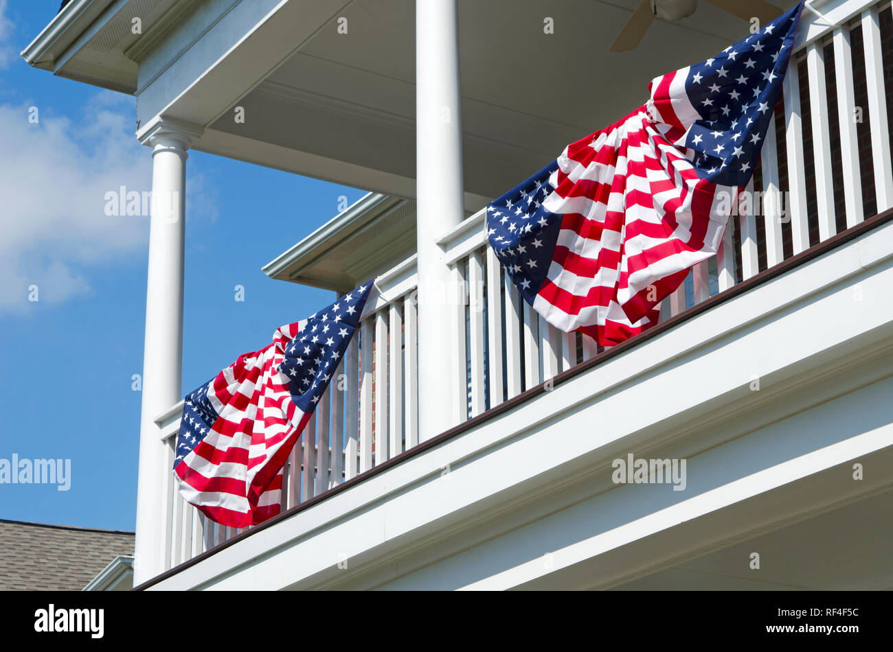 Patriotic American Flag Bunting Hung on a Brick House with a White