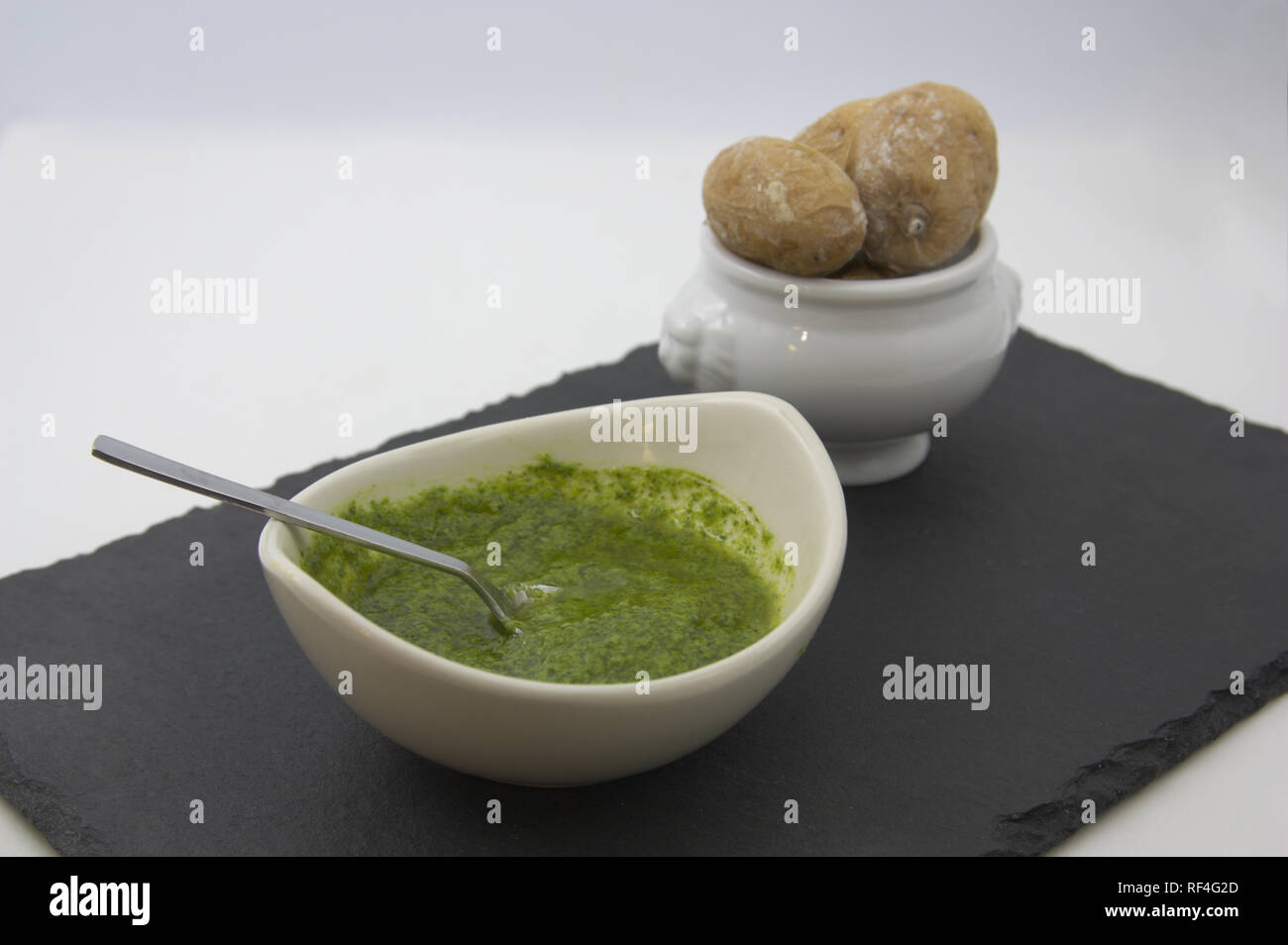 A serving of green mojo sauce with some wrinkled potatoes typical of the Canary Islands Stock Photo