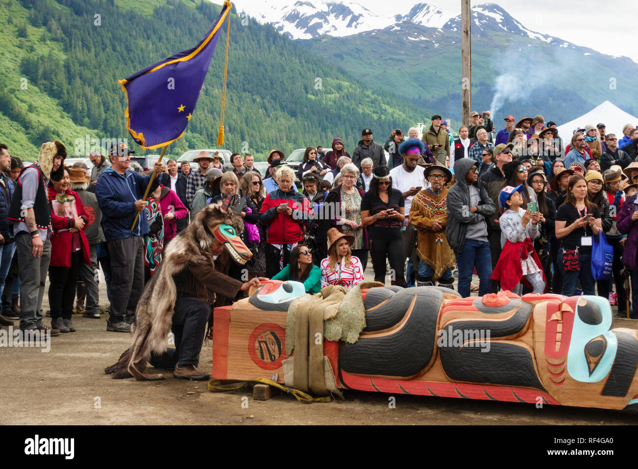 A crowd of people from the Tlingit, Tsimshian and Haida tribes gathered for a Native American Indian totem pole raising celebration, Juneau, Alaska Stock Photo