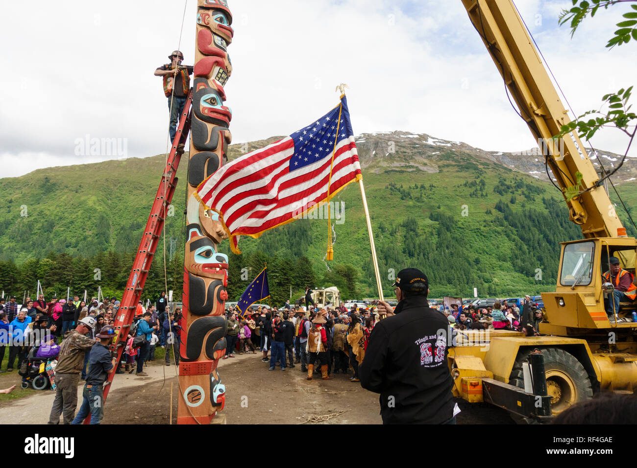 A crowd of people from the Tlingit, Tsimshian and Haida tribes gathered for a traditional Native American Indian totem pole raising, Juneau, Alaska Stock Photo