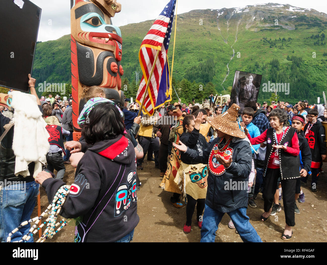 A crowd of people from the Tlingit, Tsimshian and Haida Native American Indian tribes gathered for a totem pole raising celebration, Juneau, Alaska Stock Photo