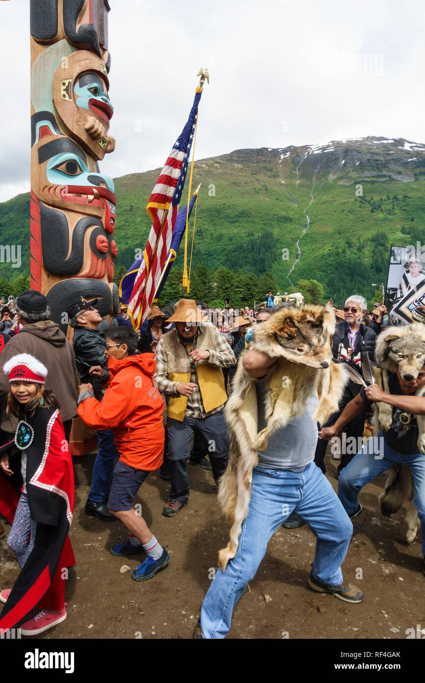 A crowd of people from the Tlingit, Tsimshian and Haida Native American Indian tribes gathered for a totem pole raising, Juneau, Alaska Stock Photo