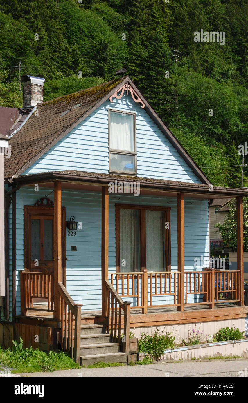 A typical old historic wood frame house in Juneau, Alaska with brightly painted clapboard siding Stock Photo