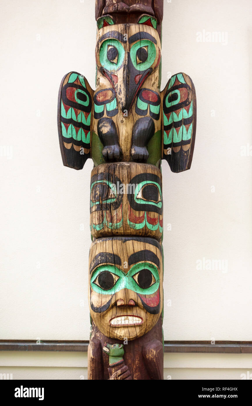 A traditional Northwest Coast Native American Tlingit Indian totem pole outside the Alaska State governor's mansion in Juneau, Alaska, United States Stock Photo