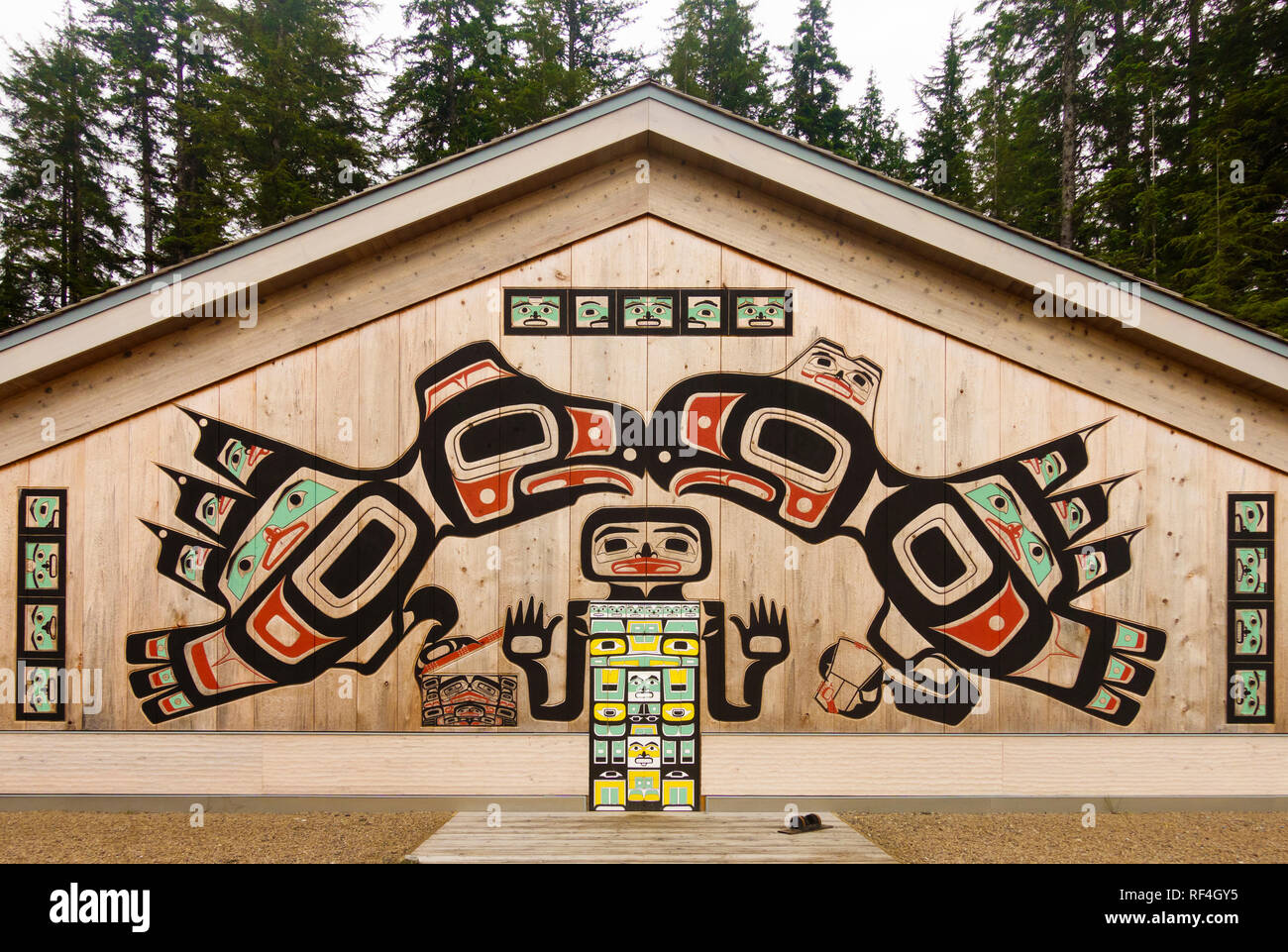 Carved and painted cedar wood panels decorate the Tlingit Huna Native American tribal clan house at Bartlett Cove, Glacier Bay National Park, Alaska. Stock Photo
