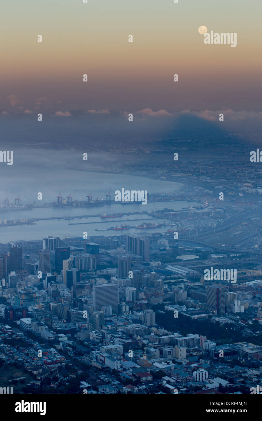 Hiking Lion's Head for full-moon views over Cape Town, South Africa is a popular activity. The mountain casts a sunset shadow over the city bowl Stock Photo