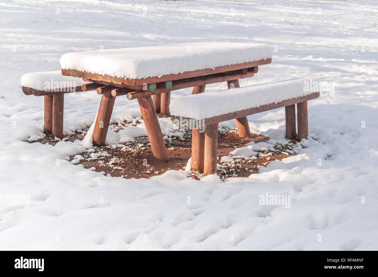 Wooden bench and table covered with snow in the city winter season Stock  Photo - Alamy