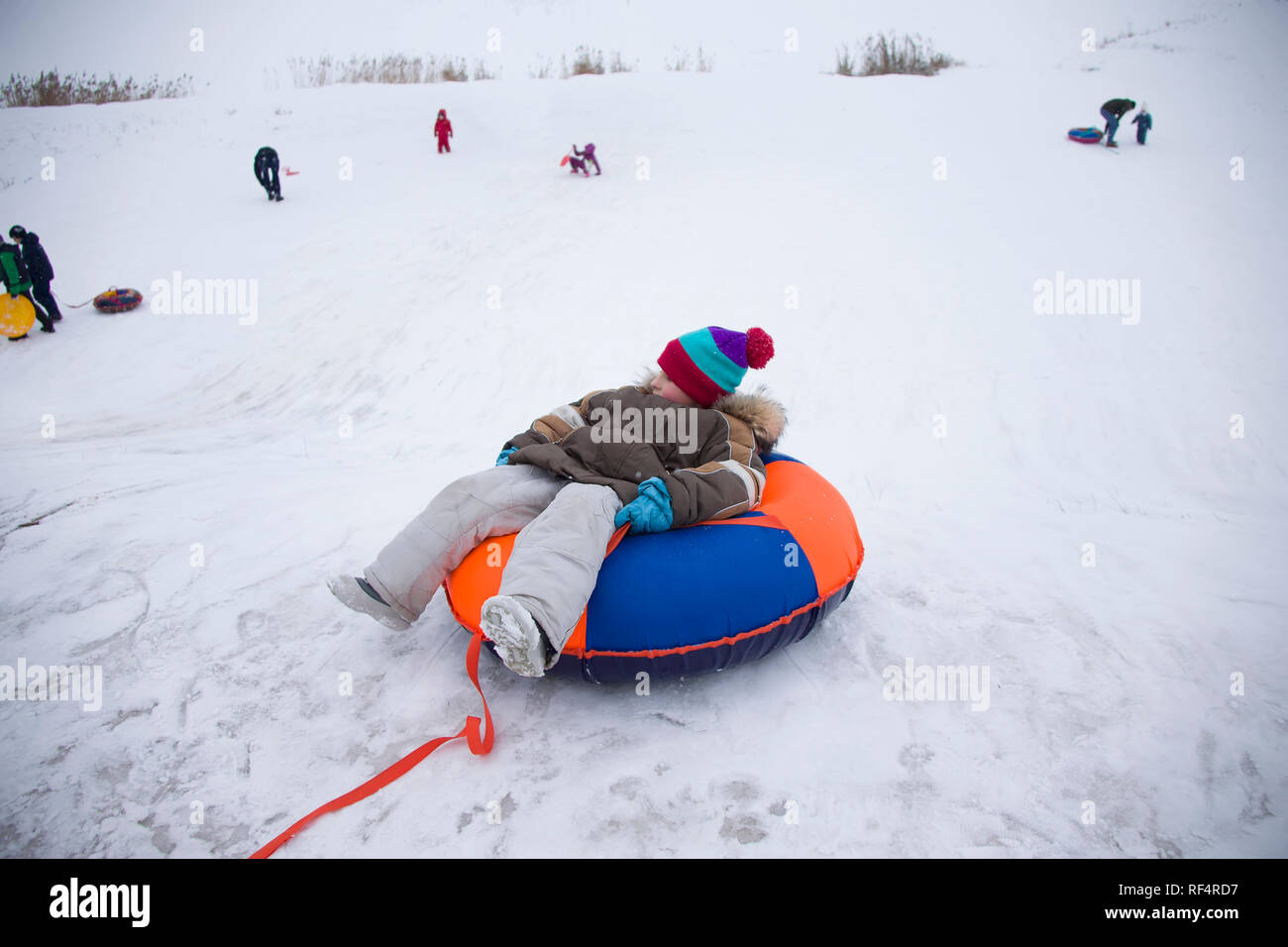 Sledding.Happy child on vacation. Winter fun and games.Little boy ...