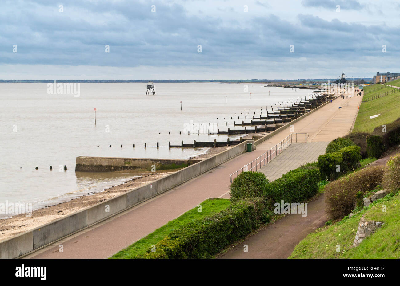 Dovercourt beach and lighthouse with people walking along the promenade