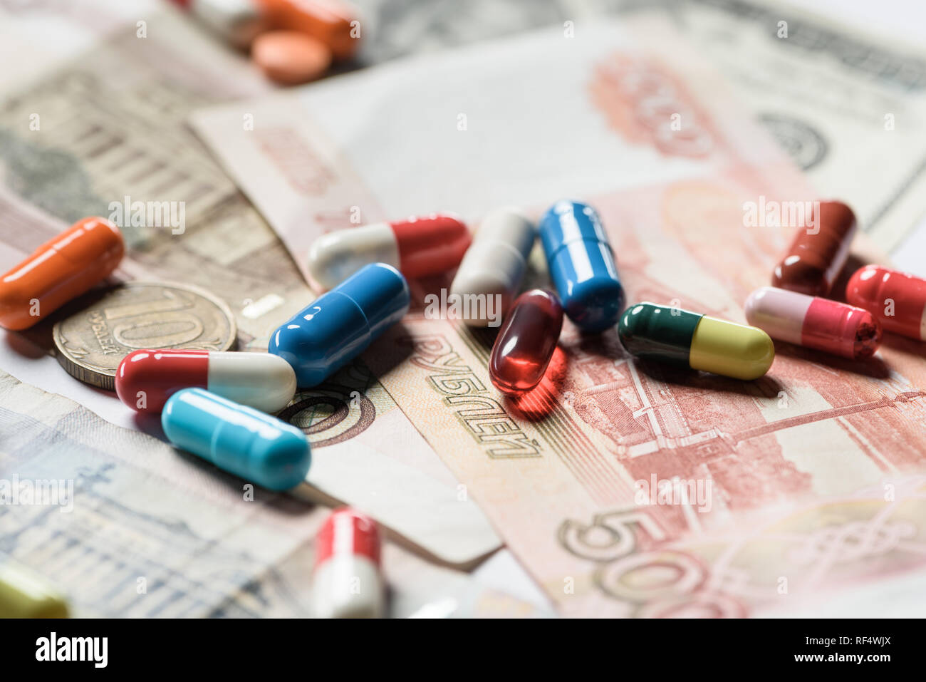 selective focus of colorful pills on banknotes background Stock Photo ...