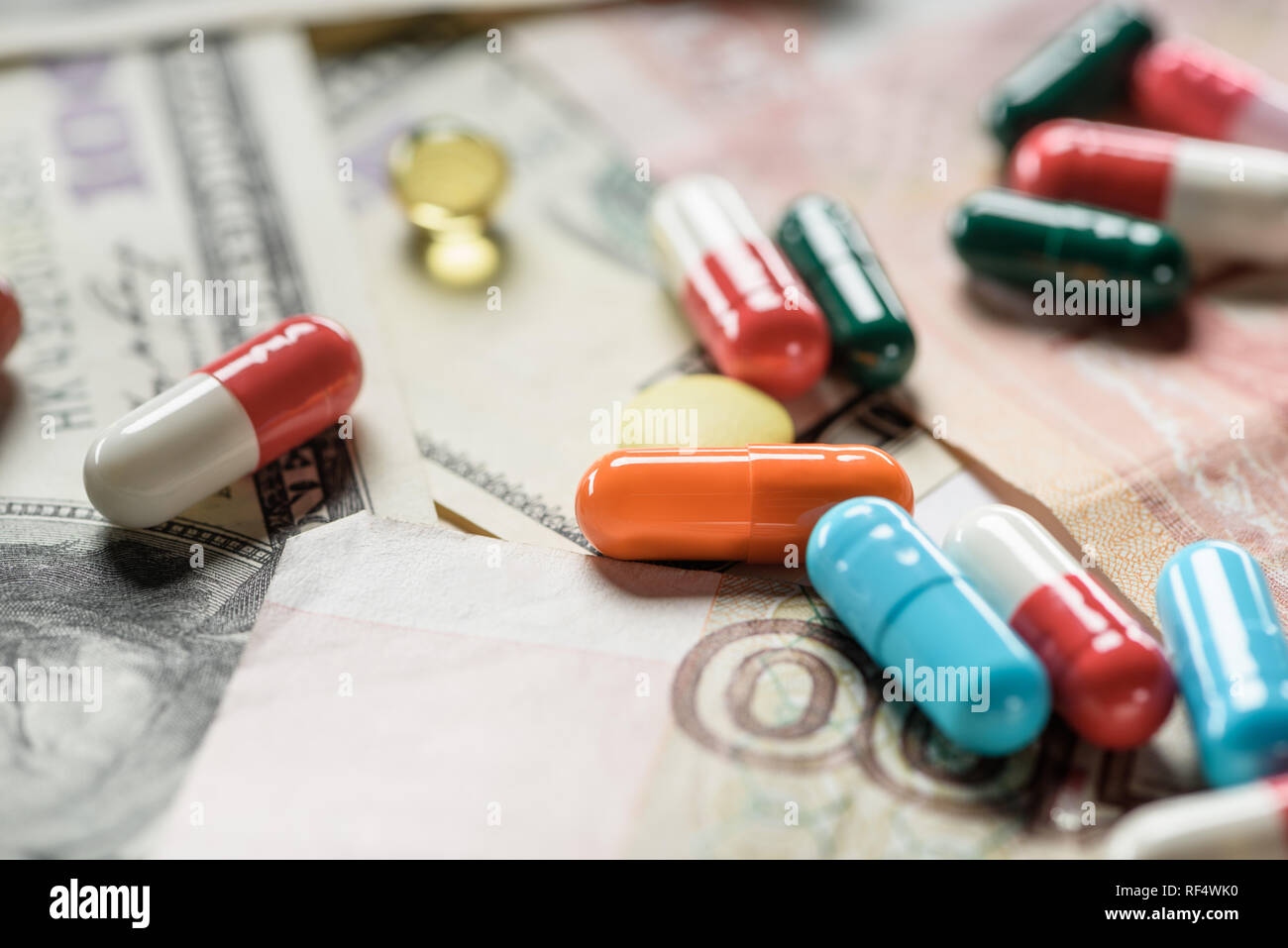 selective focus of bright pills on banknotes background Stock Photo - Alamy