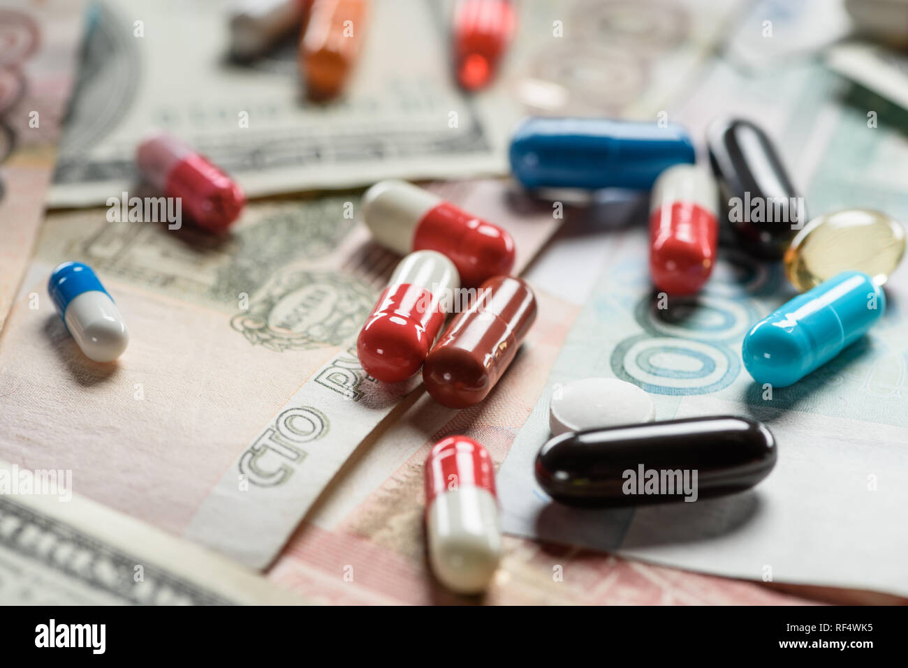 close up of multicolored pills on banknotes background Stock Photo - Alamy