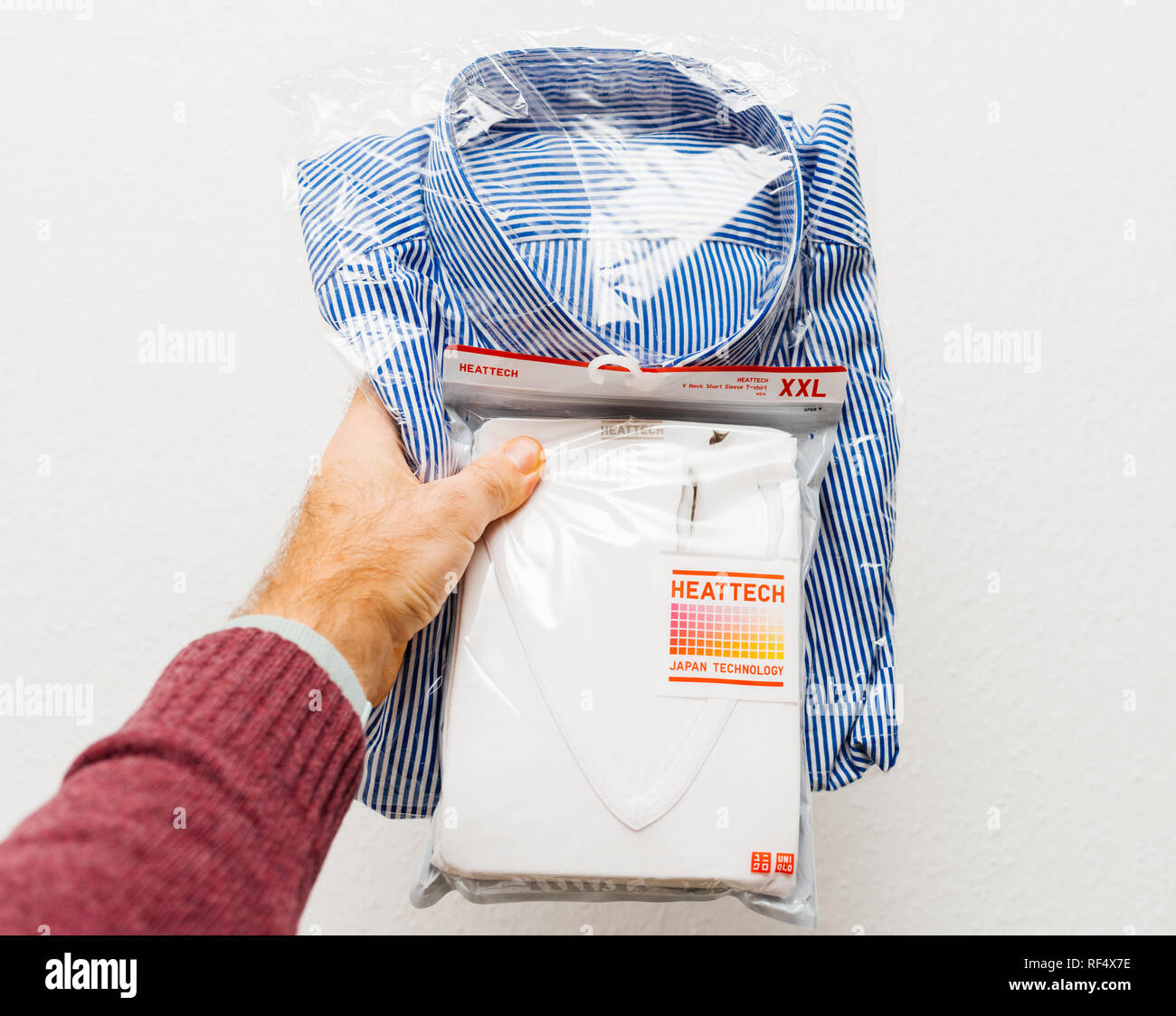 Paris, France - Dec 21, 2018: Man holding against white background a new  package with v-neck t-shirt manufactured by Uniqlo Japanese casual wear  designer, manufacturer and retailer Stock Photo - Alamy