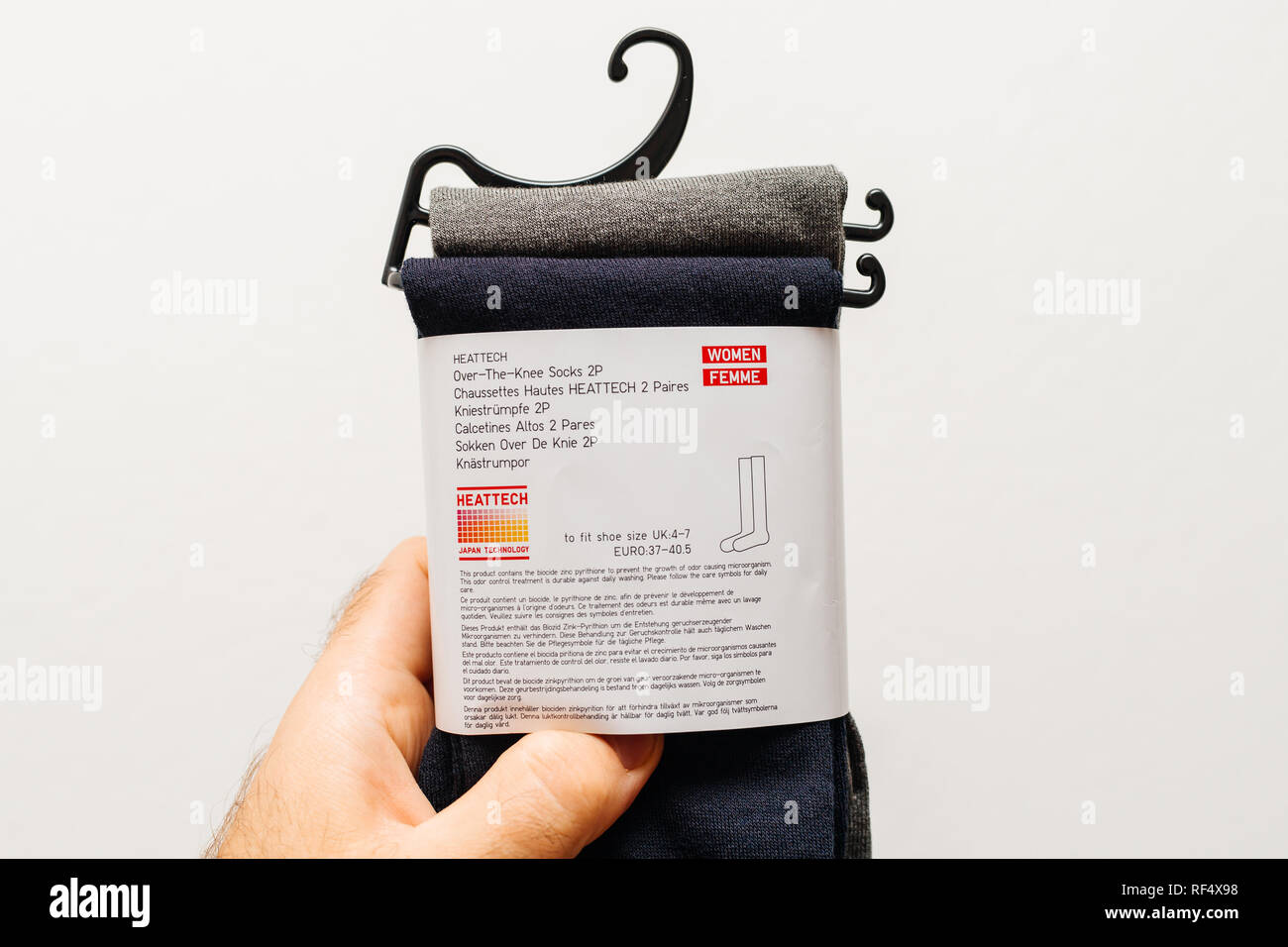 Paris, France - Dec 21, 2018: Man holding against white background a new  package with over-the-knee-socks manufactured by Uniqlo Japanese casual  wear designer, manufacturer and retailer Stock Photo - Alamy