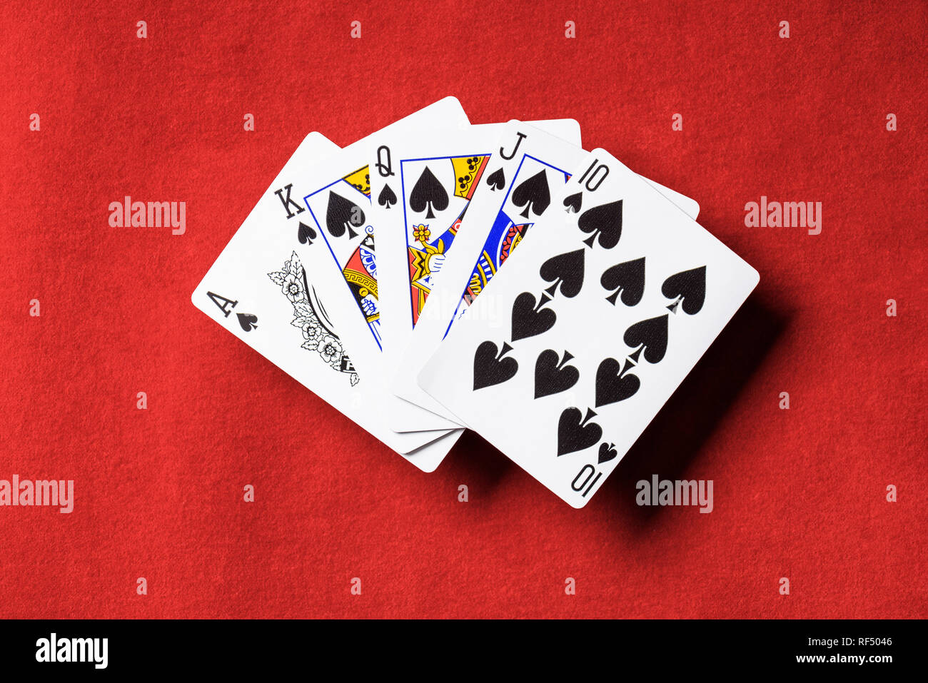 top view of red poker table and unfolded playing cards with spades suit  Stock Photo - Alamy