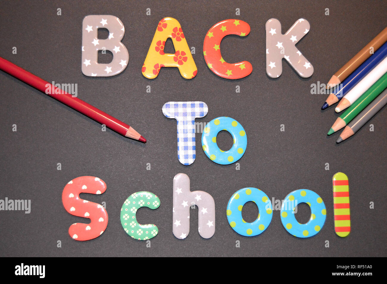 Illustration of the back to school with letters and colored pencils Stock Photo