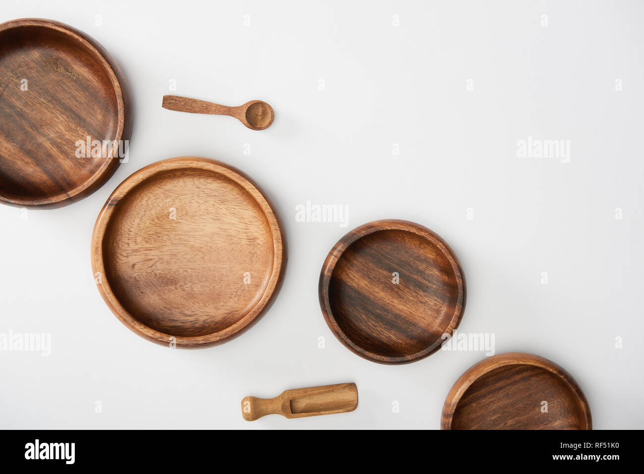 top view of wooden bowls, spoon and spatula on white background Stock Photo