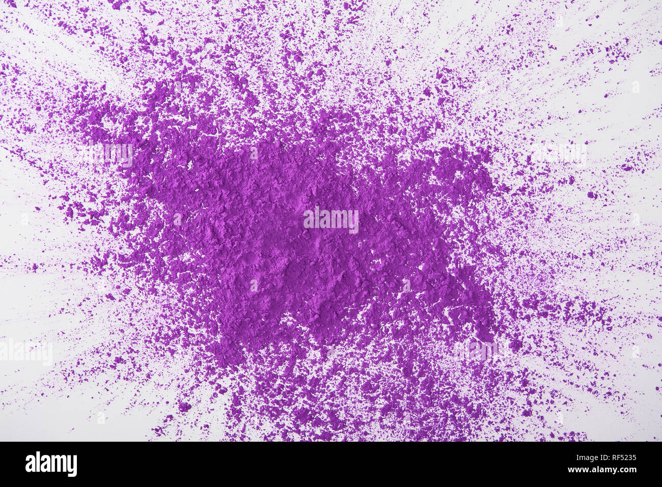 Holly Powder Exploding top view of explosion of purple holi powder on white background Stock ...